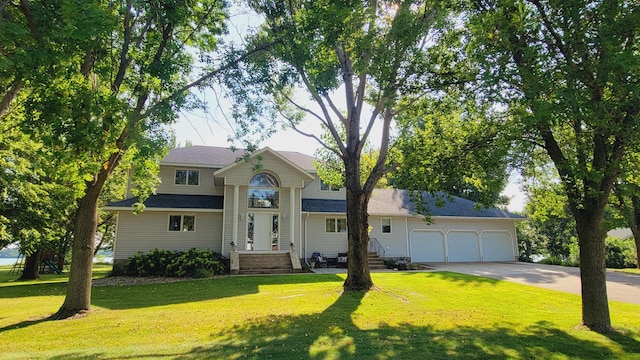 view of front facade with a garage and a front yard