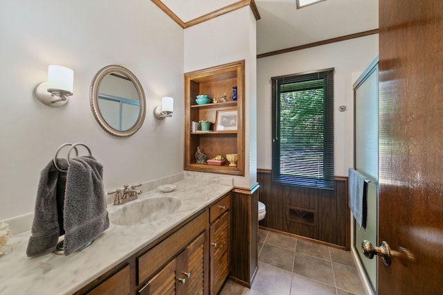 bathroom featuring vanity, crown molding, toilet, and tile patterned floors