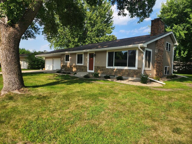 ranch-style house with a front yard and a garage