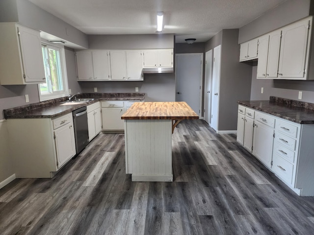 kitchen with white cabinets, dishwasher, and a sink