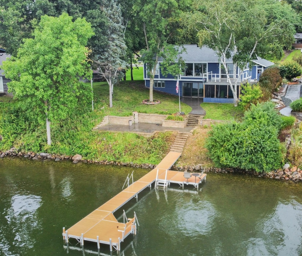 dock area featuring a lawn and a water view