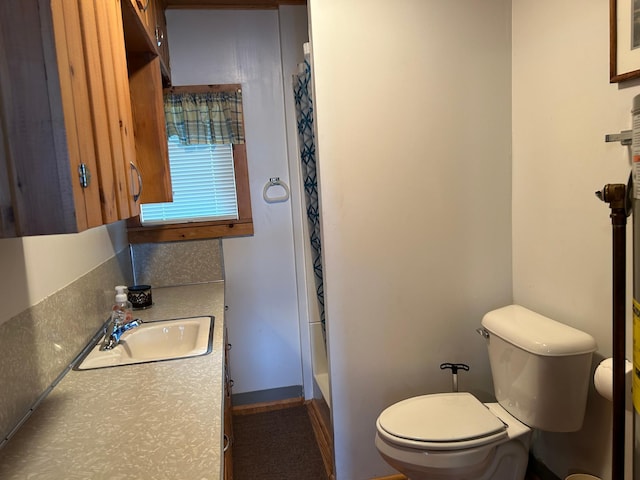 bathroom featuring toilet and vanity