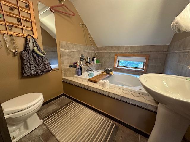 bathroom with vaulted ceiling and toilet