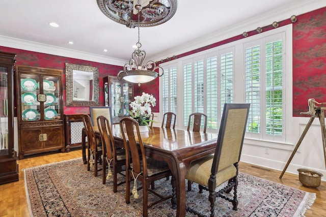 dining room with light hardwood / wood-style floors and ornamental molding