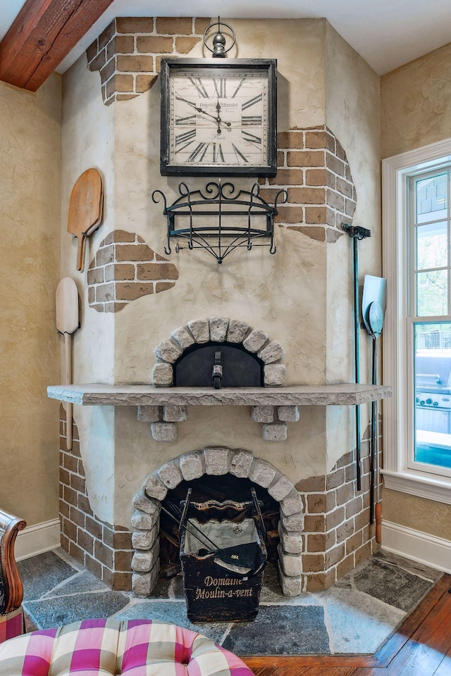 details featuring hardwood / wood-style floors and a stone fireplace