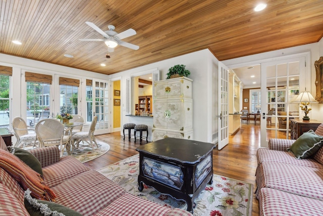 living room with ceiling fan, french doors, hardwood / wood-style floors, and wooden ceiling