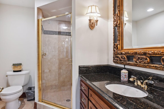 bathroom with tile patterned flooring, vanity, walk in shower, and toilet