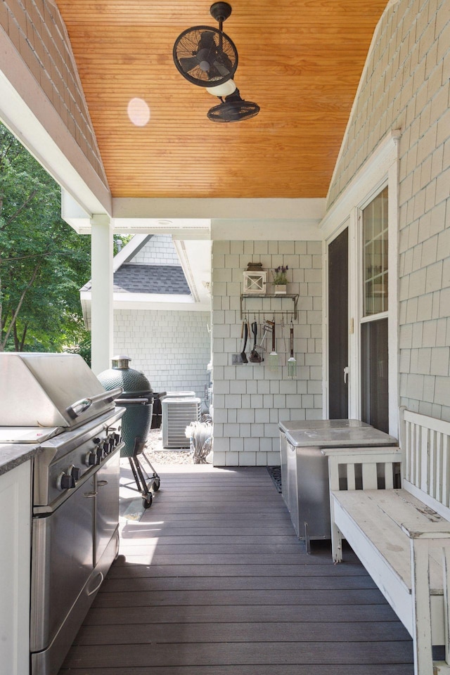 wooden terrace with ceiling fan, cooling unit, and a grill