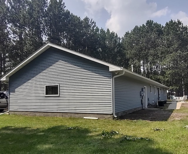 view of home's exterior featuring a yard and cooling unit