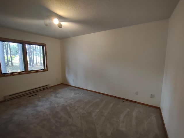 carpeted empty room with a textured ceiling and a baseboard radiator