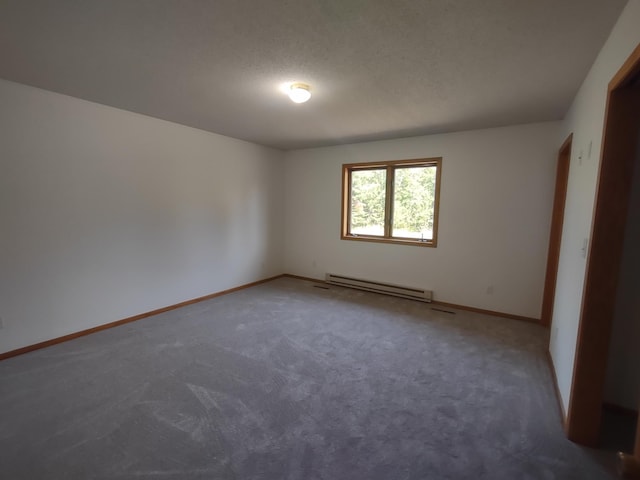 carpeted spare room with a textured ceiling and baseboard heating