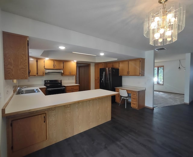 kitchen with kitchen peninsula, an inviting chandelier, black appliances, dark wood-type flooring, and sink