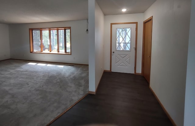 foyer with dark carpet