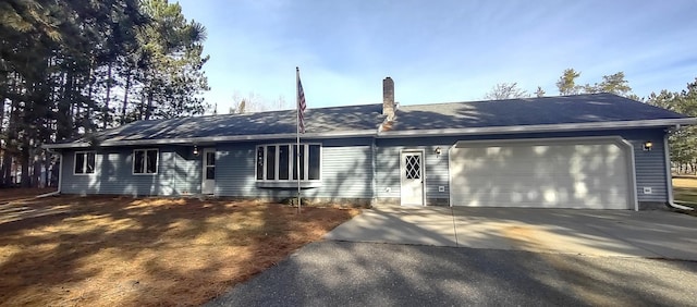 ranch-style home featuring a garage