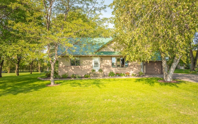 view of front of property with a garage and a front lawn