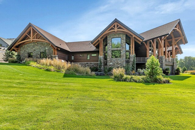 rear view of property featuring a lawn