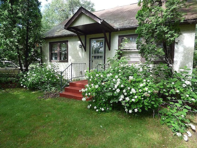 view of exterior entry with a yard