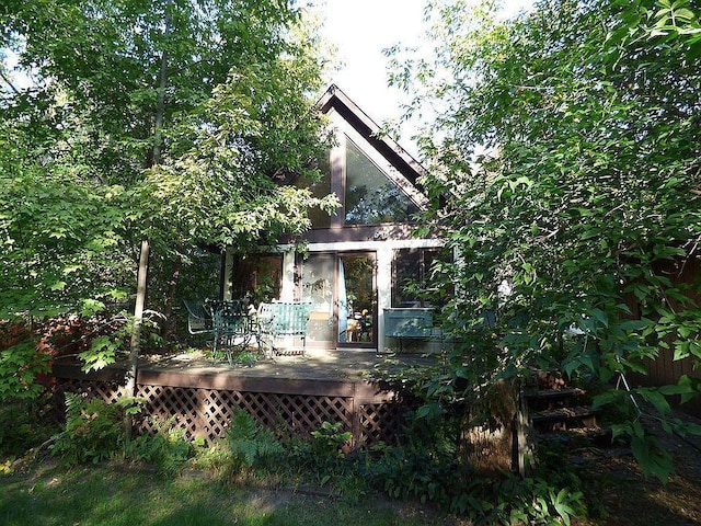 rear view of property with a wooden deck