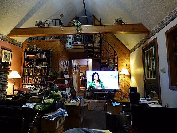 interior space featuring lofted ceiling with beams and a textured ceiling