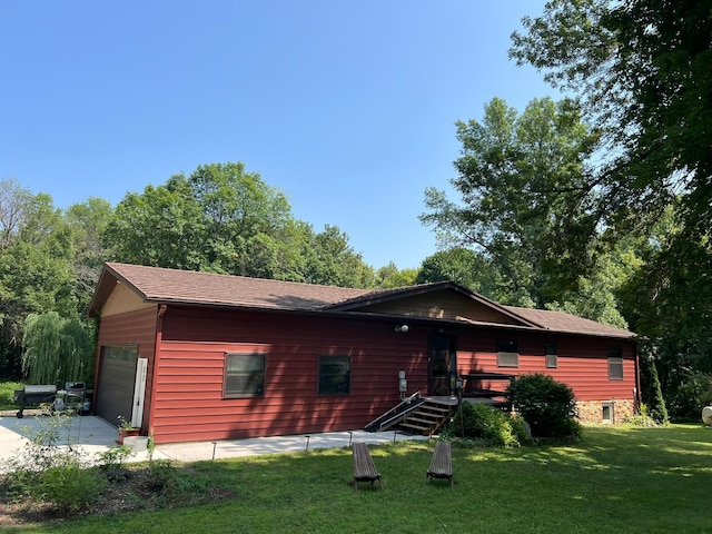 back of house with a patio, a garage, and a yard