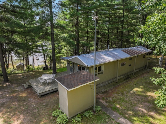 back of property featuring a wooden deck