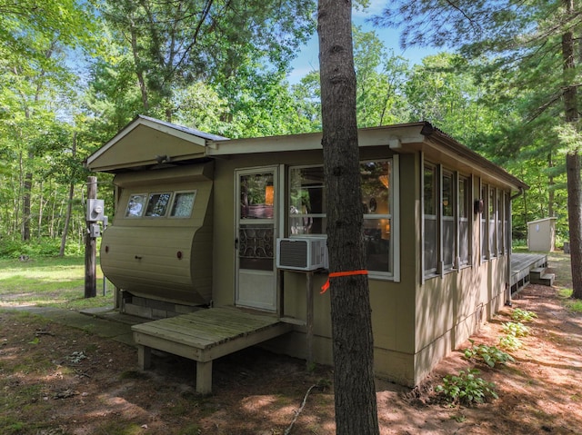 rear view of house featuring cooling unit