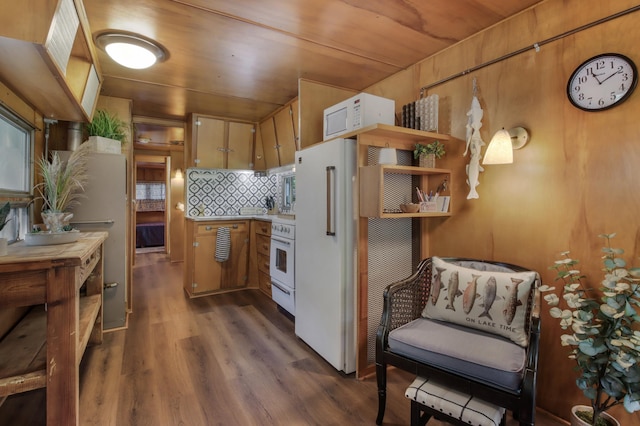 kitchen featuring decorative backsplash, dark hardwood / wood-style floors, and white appliances