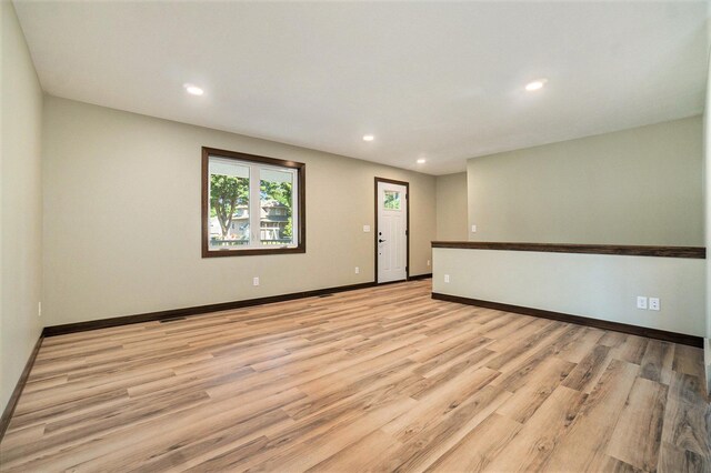 spare room featuring light wood-type flooring