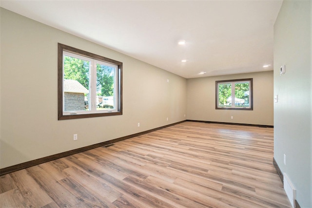 unfurnished room featuring recessed lighting, baseboards, visible vents, and light wood finished floors