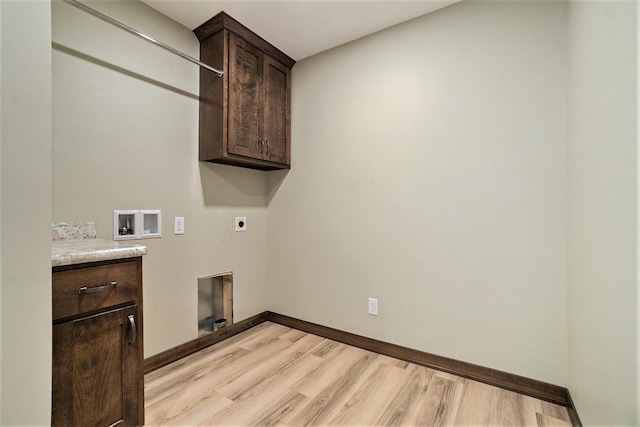 clothes washing area featuring washer hookup, baseboards, light wood-style floors, cabinet space, and electric dryer hookup