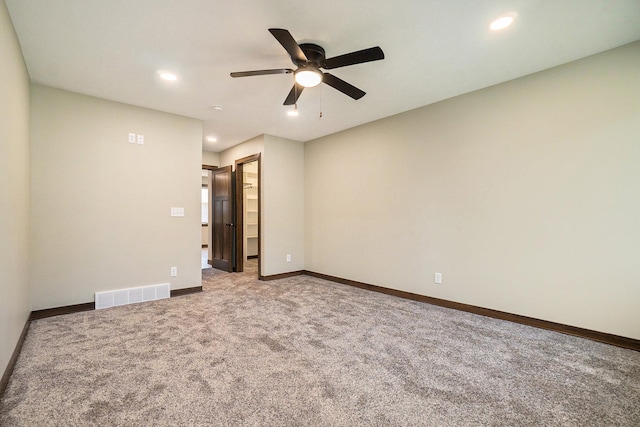 carpeted empty room with ceiling fan, recessed lighting, visible vents, and baseboards