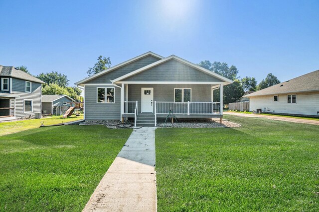 bungalow with a front yard and a porch