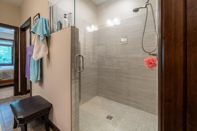 ensuite bathroom with a shower stall and connected bathroom