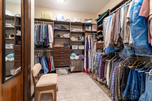 walk in closet with wood finished floors