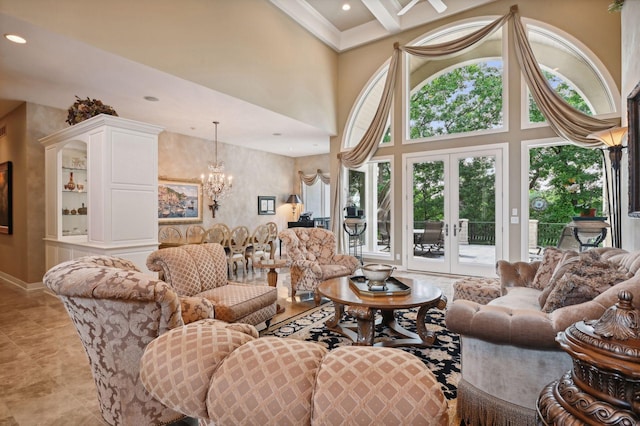 living room featuring a notable chandelier, beam ceiling, french doors, and a high ceiling