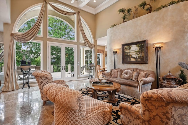 living room featuring french doors, ornamental molding, and a high ceiling