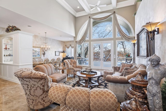 living room with a towering ceiling, ceiling fan with notable chandelier, beamed ceiling, coffered ceiling, and french doors