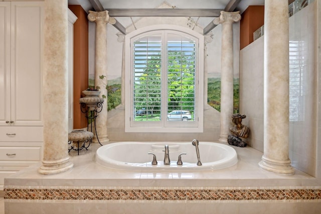 bathroom featuring a bathtub and decorative columns