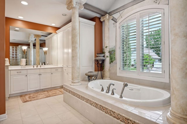 bathroom featuring a relaxing tiled tub, tile patterned floors, vanity, and ornate columns