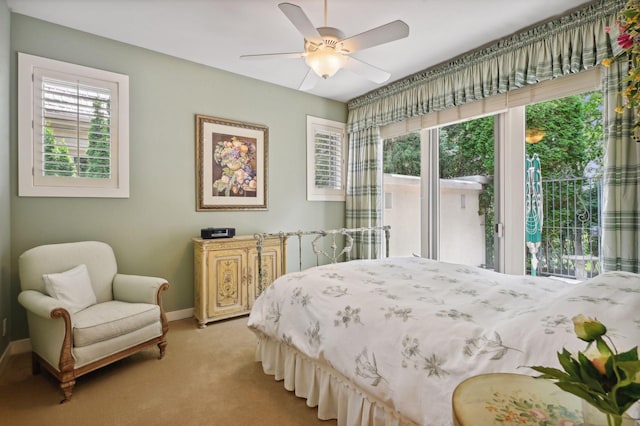 carpeted bedroom with multiple windows, access to outside, and ceiling fan