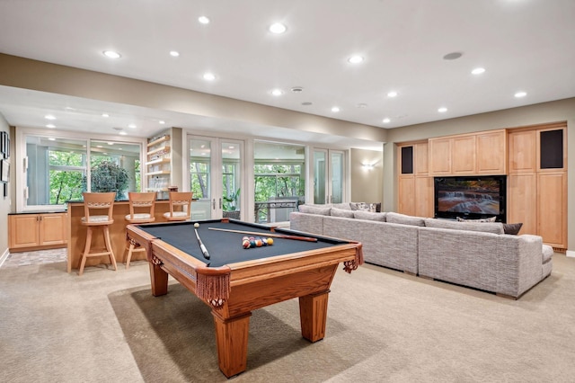 recreation room with billiards, plenty of natural light, and light carpet