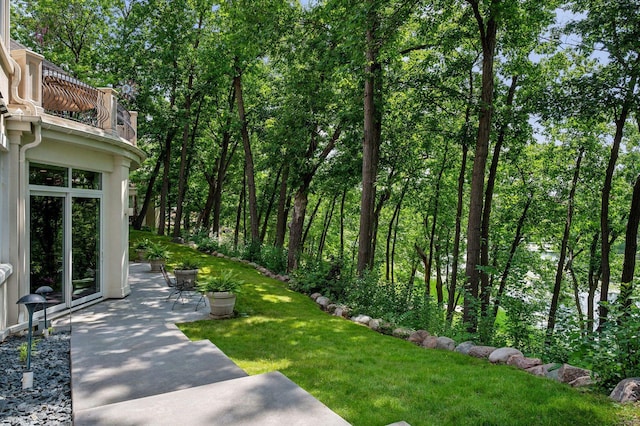 view of yard featuring a balcony and a patio area