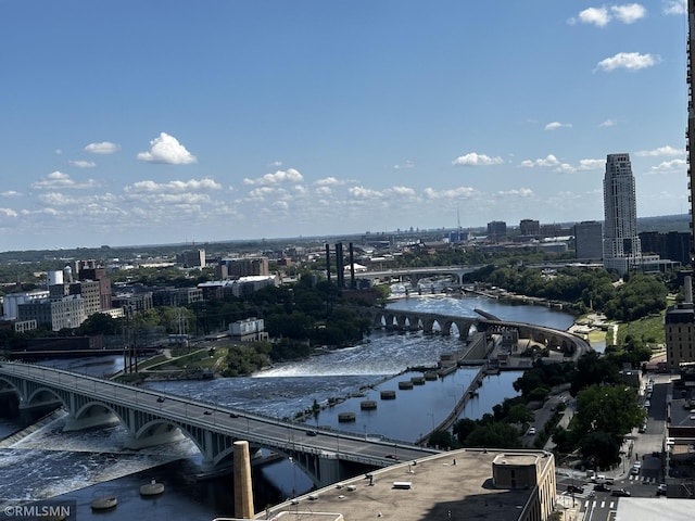 drone / aerial view featuring a water view and a city view