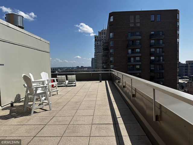 view of patio with a balcony and a city view