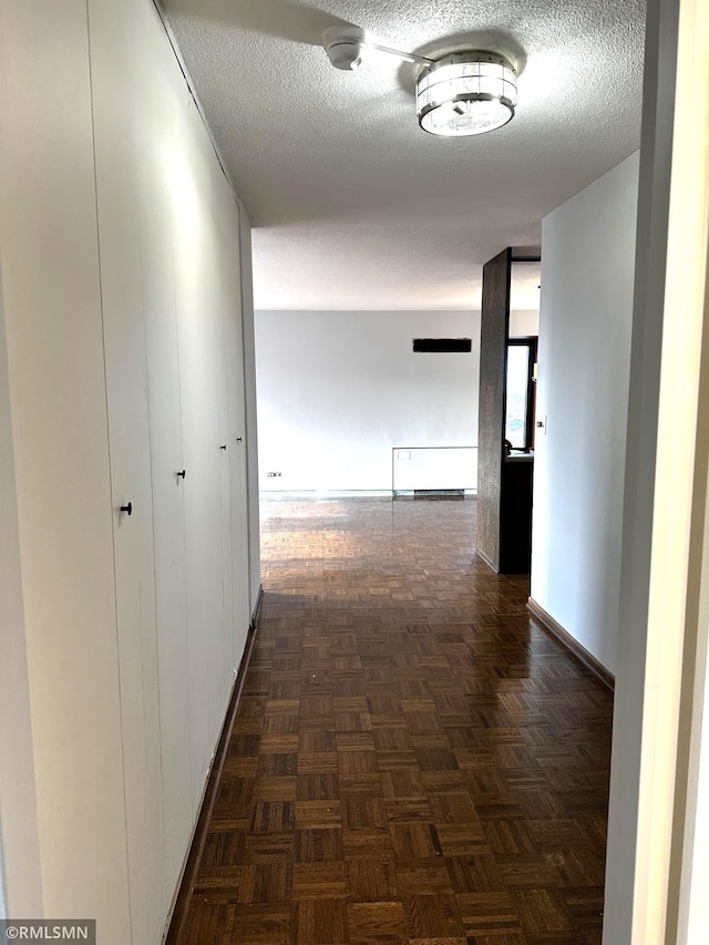 corridor featuring a textured ceiling