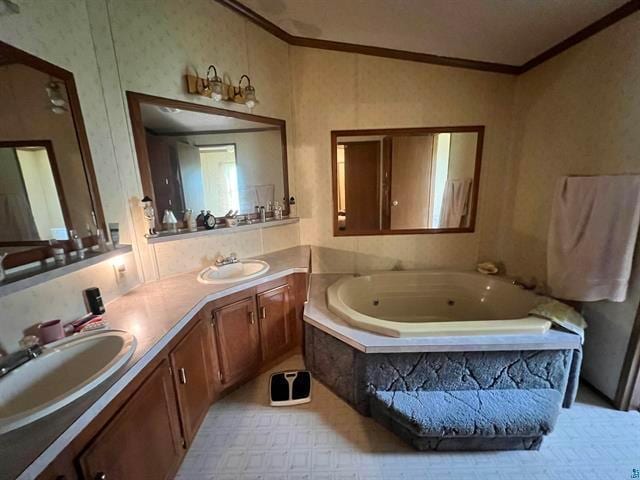 bathroom featuring ornamental molding, vanity, and tiled bath