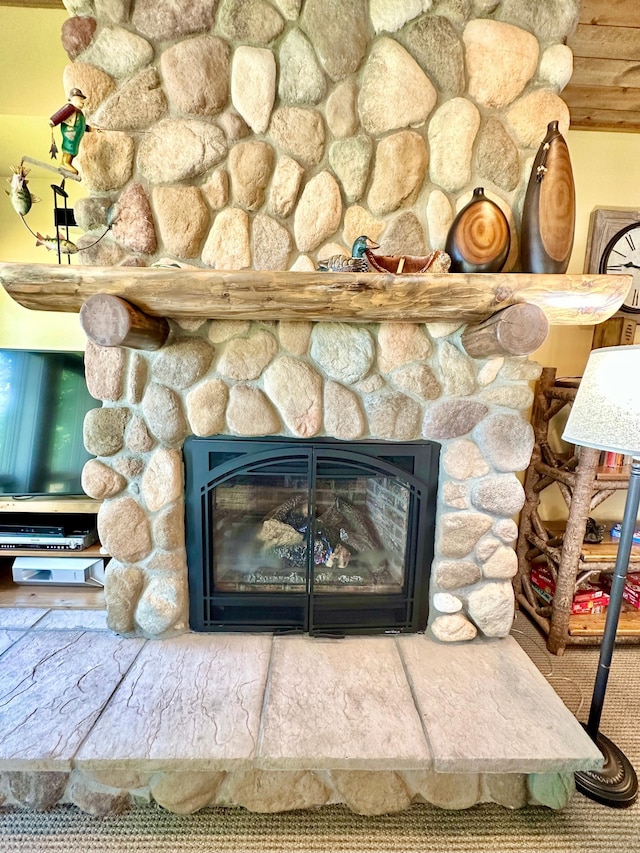 interior details with a stone fireplace