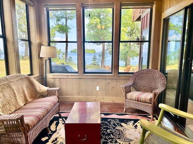 sunroom / solarium featuring a water view and a healthy amount of sunlight