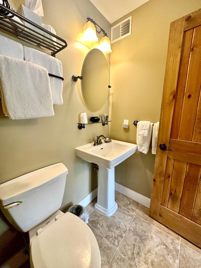 bathroom featuring tile patterned floors and toilet