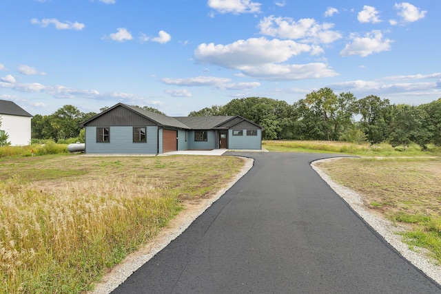 single story home with an outdoor structure and a garage